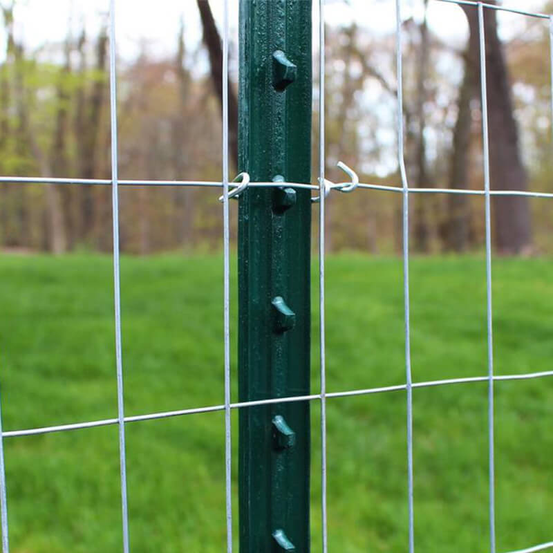 farm used studded T fence post with wire mesh fence